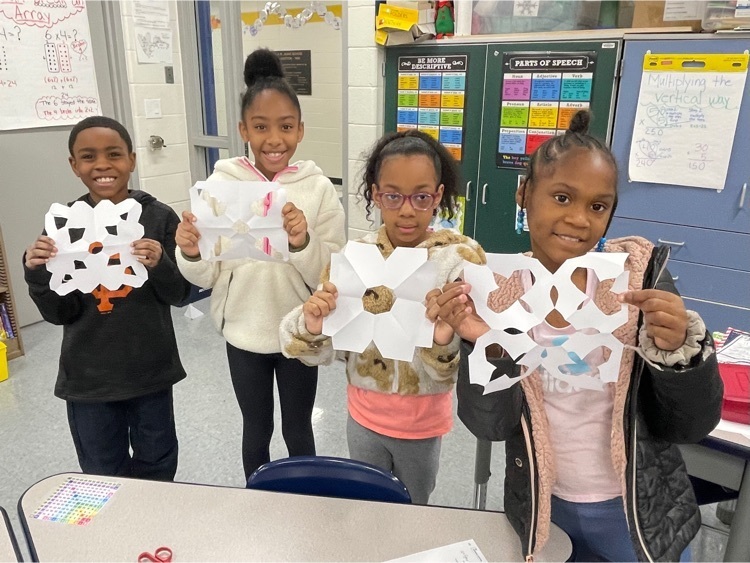 3rd grade students with their snowflakes 