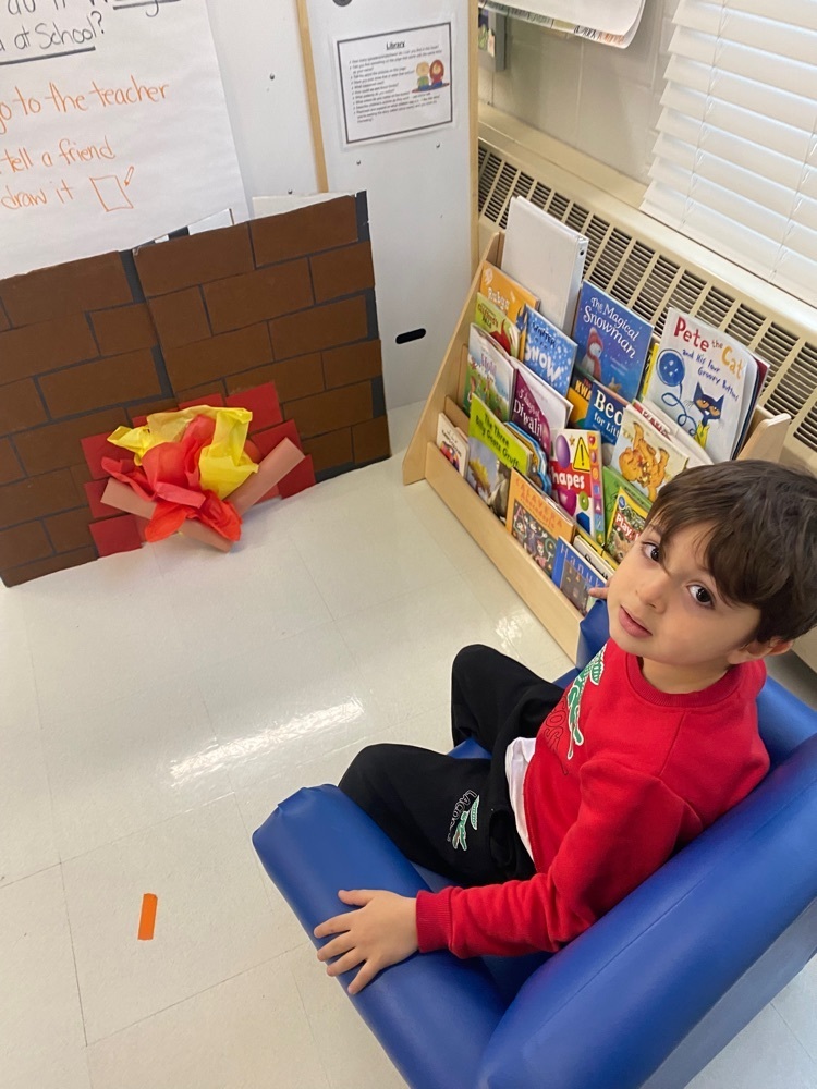 cozying up with a book at our classroom fireplace 