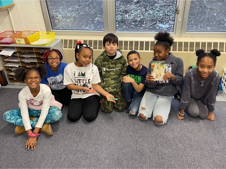 3rd grade students showing off the book they just finished!